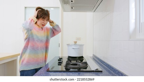 Worried Asian Woman Fail To Turn On Gas Stove In The Kitchen At Home During Winter