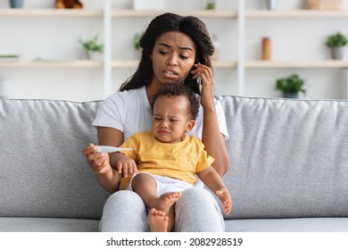 Worried Black Woman With Little Baby Holding Thermometer And Calling To Doctor, Concerned African American Mother Consulting With Pediatrist About High Temperature In Child Treatment, Copy Space