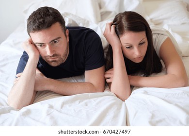 Worried And Bored Lovers Couple After A Fight Lying In The Bed