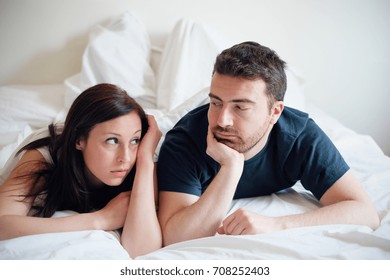 Worried And Bored Lovers Couple After A Fight Lying In The Bed