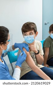 Worried Boy Receives Vaccine For Virus Protection In Clinic.