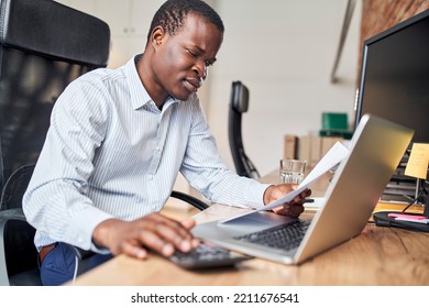 Worried Businessman Calculating Business Expenses Doing Paperwork In Office