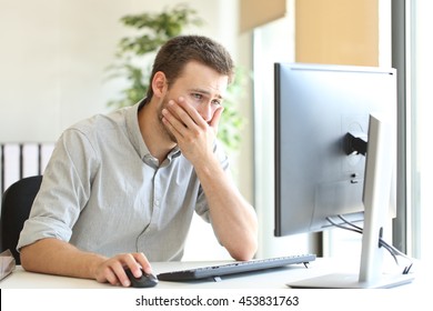 Worried Businessman Working Trying To Solve Troubles On Line With A Desktop Computer At Office