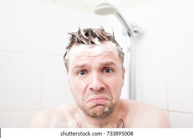 Worried Caucasian Foamed Young Man After The Water In The Shower Was Turned Off, Looking At The Camera. Shower Breakdown Or Hot Water Shut-off.