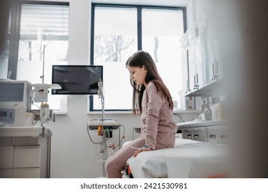 Worried children patient in emergency room, sitting on bed, waiting. Concept of emotional support and friendliness for young kid patient. - Powered by Shutterstock