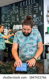 Worried Coffee Shop Owner Reviewing Business Accounts