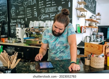 Worried Coffee Shop Owner Reviewing Business Accounts