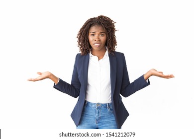 Worried Confused Female Manager Making Do Not Know Gesture. Young Black Business Woman Standing Isolated Over White, Looking At Camera, Shrugging. Doubt Concept