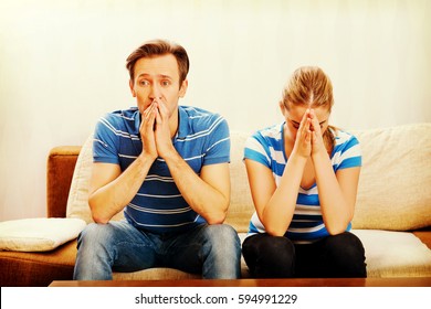 Worried Couple After Fight Sitting On Sofa