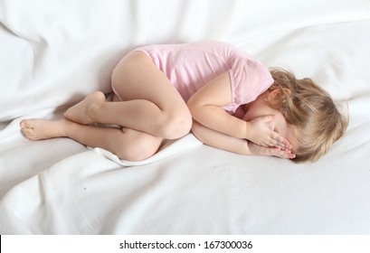 Worried Crying Child Lying On A Bed. A11y