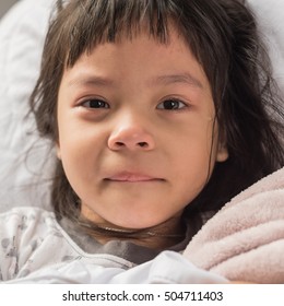 Worried Crying Child Lying On A Bed.