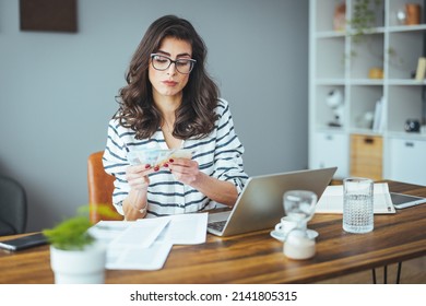 Worried And Desperate Woman Banking And Accounting Home Monthly And Credit Card Expenses With Computer Laptop Doing Paperwork In Living Cost Stress And Paying Bills Problem.