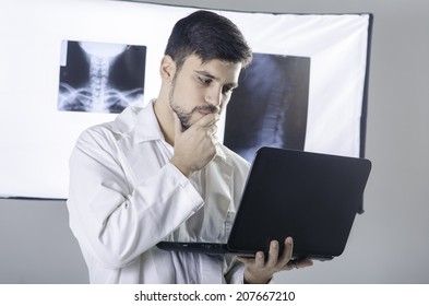 Worried Doctor Looking At Laptop