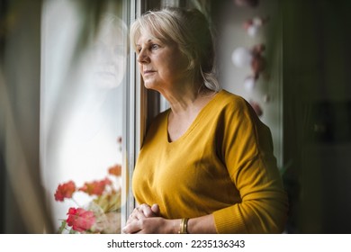 Worried elderly woman looking in window
 - Powered by Shutterstock