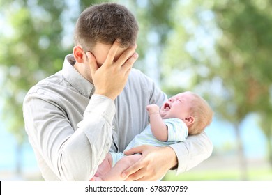 Worried Father And Baby Crying Outdoors