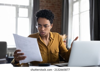 Worried frustrated Black professional woman reading paper notification with bad news, getting problems, dismissal, bankruptcy. Student girl receiving document from college, rejection notice - Shutterstock ID 2132665877