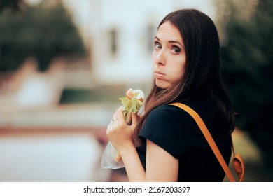 
Worried Girl Having A Sandwich Outside. Picky Eater Not Liking The Takeout Food Snack 
