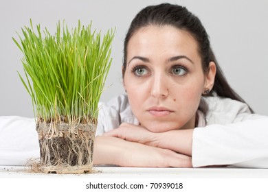 Worried Girl Watching A Plant Grow.