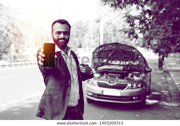 worried Indian Businessman with vehicle/car\
breakdown, talking on\
phone