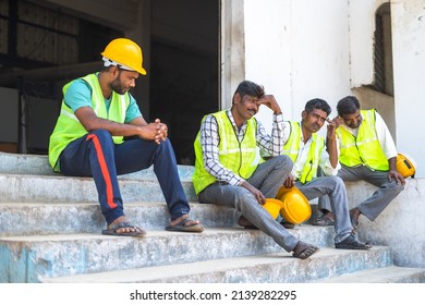 Worried Industrial Workers Sitting Outside The Factory Due To Closure - Concept Of Job Loss, Unemployment And Blue Collar Jobs