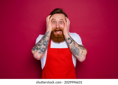 Worried Isolated Chef With Beard And Red Apron