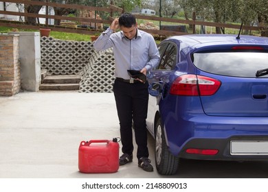 Worried Man With Empty Wallet In Hand And Car In The Backyard Without Gasoline. Fuel Cost Issue