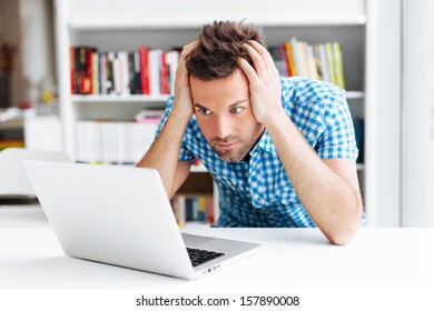 Worried Man Looking On Laptop