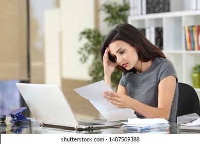 Worried office worker complaining reading bad news in a paper letter