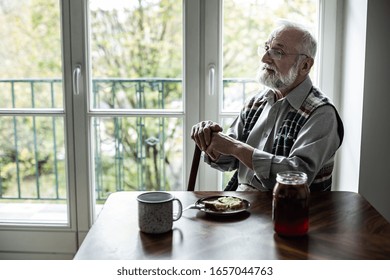 Worried Older Man Sitting Alone In The Morning In His Home