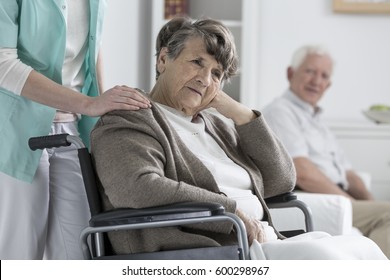 Worried Older Woman On A Wheelchair In A Nursing Home