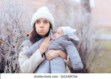 Worried Overprotective Mother Holding Baby In Cold Weather. Protective Mom And Daughter In Wintertime Season
