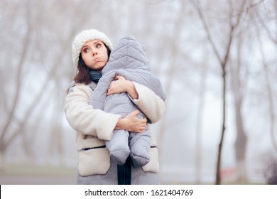 Worried Overprotective Mother Holding Baby In Cold Weather. Protective Mom And Daughter In Wintertime Season
