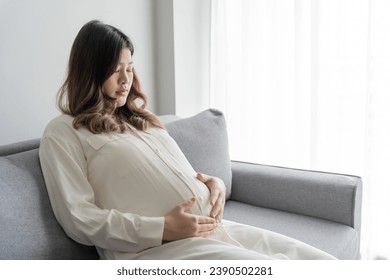 worried pregnant woman concerned and anxious woman in pregnancy overthinking worrying about pregnancy problem Pregnancy depression Mental health concept - Powered by Shutterstock