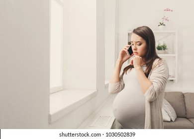 Worried Pregnant Woman Talking On Phone Copy Space. Sad Expectant Lady Having Serious Conversation With Her Doctor. Healthcare, Consultation, Pregnancy Problems, Childbirth Concept