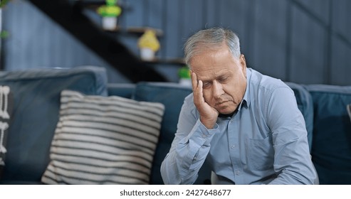 Worried retired old senior man sitting alone on sofa look away feel sorrow abandoned anxiety home. Unhappy Indian middle aged male grieving think lonely depressed pensive suffer health issue problem - Powered by Shutterstock