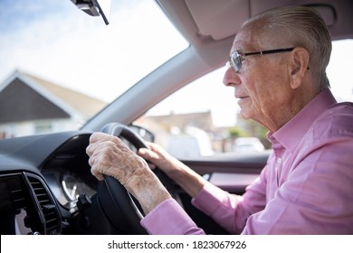 Worried Senior Male Driver Looking Through Car Windscreen