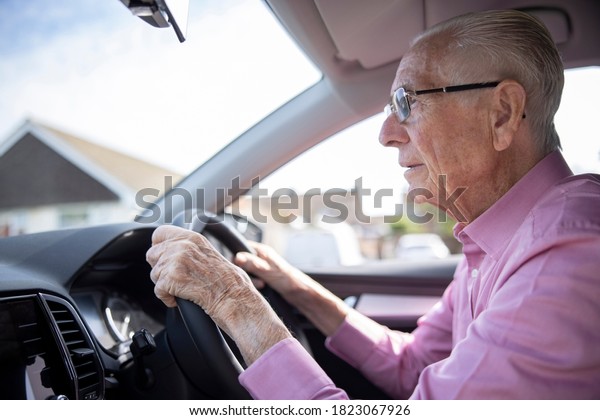 Worried\
Senior Male Driver Looking Through Car\
Windscreen