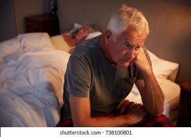 Worried Senior Man In Bed At Night Suffering With Insomnia