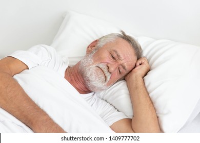 Worried Senior Retirement Man Lying Awake In His Bed