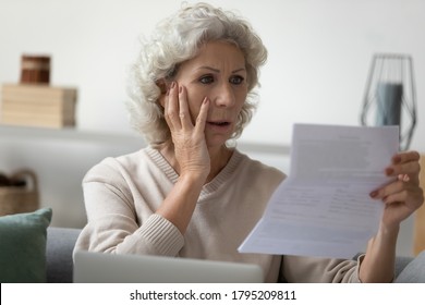 Worried senior woman reading bad news in paper letter document feels disappointed, stressed old grandma troubled with high taxes or domestic bills, concerned about bank debt, financial problem concept