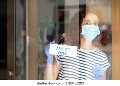 Worried Shop Assistant Opening Her Retail Business To The Public During The Pandemic Quarantine Covid 19 In Spain.