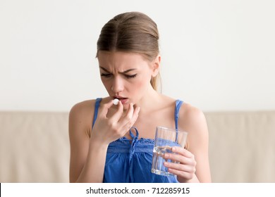 Worried Sick Young Woman Holding Pill Glass Of Water At Home, Teen Feels Ill Taking Medicine, Depressed Girl About To Take Antidepressant Pill, Emergency Contraceptive, Painkiller For Painful Periods