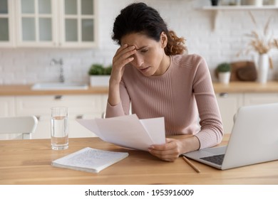 Worried Stressed Millennial Female Freelancer Scratch Forehead Think On Bank Notification About Business Bankruptcy Tax Loan Mortgage Debt. Unhappy Latin Woman Concern About Bad News In Paper Letter