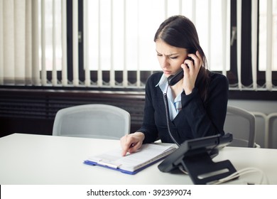 Worried Stressed Office Worker Business Woman Receiving Bad News Phone Call.Looking Confused Checking Notes And Paperwork.Manager Solving Mistake.Disputes,problems,Complaint,grievances At Work.