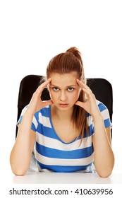 Worried Teenage Woman Sitting Behind Desk