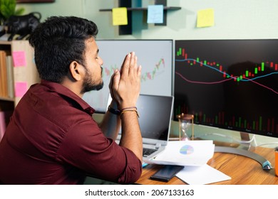 Worried Trader Praying God To Make Profit Or Stock Market To Go Up Infront Of Charts On Computer Screan - Concept Of Risk In Crypto Trading And Investing On Equity Shares