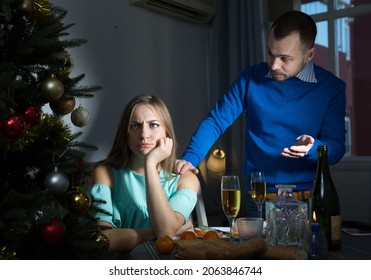 Worried Unhappy Couple Having Quarrel Discussing Problems During Christmas Dinner