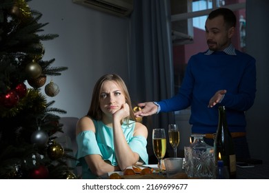 Worried Unhappy Couple Having Quarrel Discussing Problems During Christmas Dinner