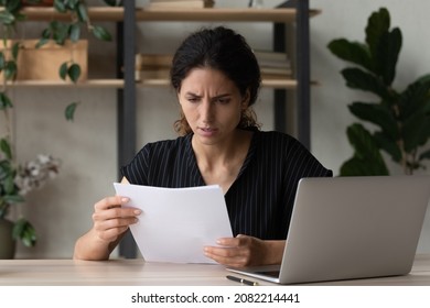 Worried unhappy latin businesswoman enterpreneur read paper letter about loan credit denial unexpected debt tax overdue. Stressed troubled woman employee thinking on business problem in bank notice