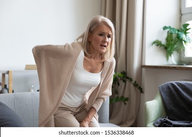 Worried Upset Middle Aged Mature Woman Feel Hurt Sudden Back Ache Touch Sore Spine At Home Alone, Tired Mature Senior Grandmother Having Lower Lumbago Backache Injury Spinal Pain, Backpain Concept